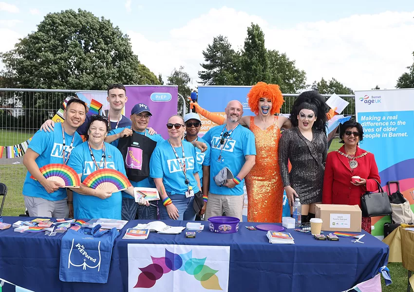 A group photo of the sexual health team at Pride, posing with 2 with drag queens and the Mayor of Barnet