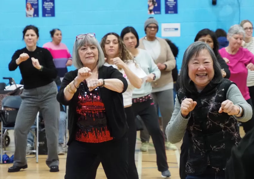 A group of women exercising and smiling together