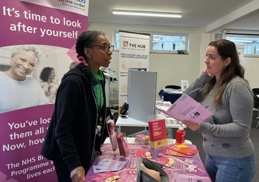 Picture of a female speaking & raising cancer awareness to a lady.