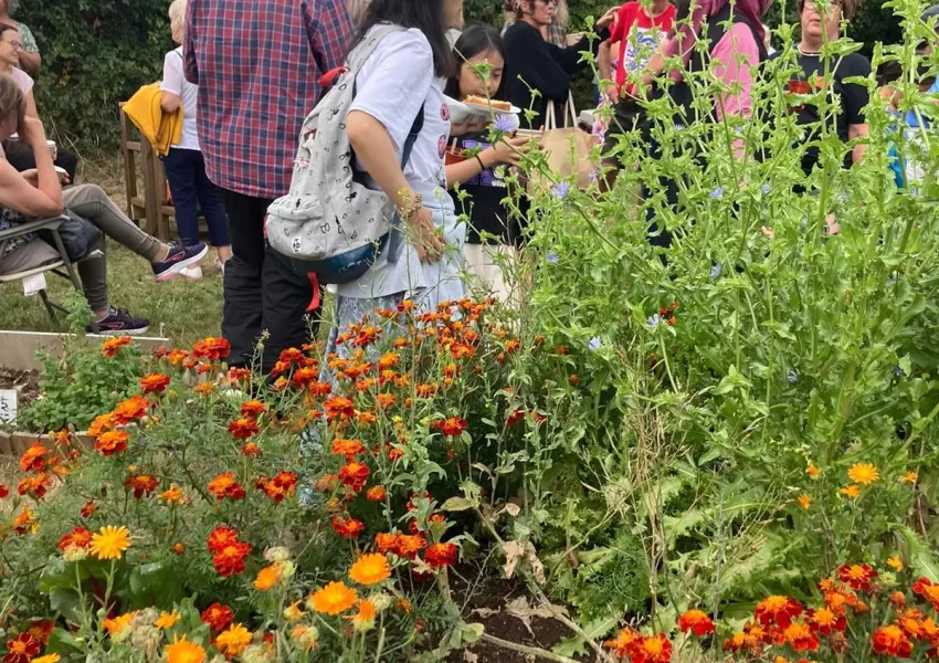 people in a garden with flowers