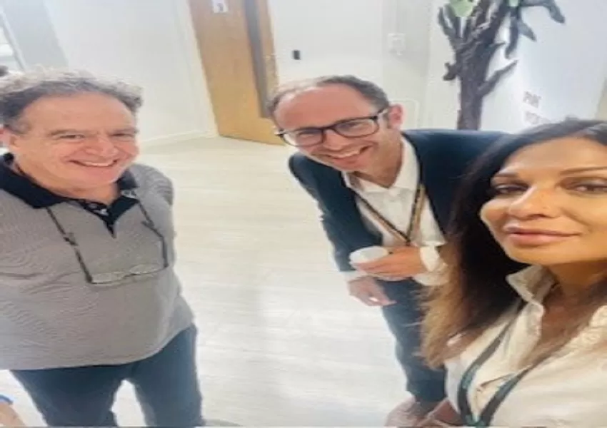 Three people posing for a photo looking into the camera