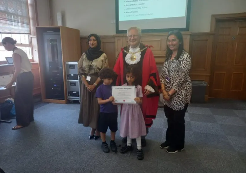 The mayor awarding certificates to children