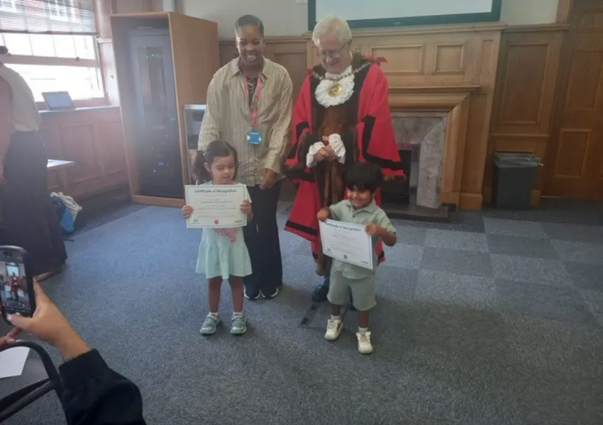 The mayor awarding even more certificates to children