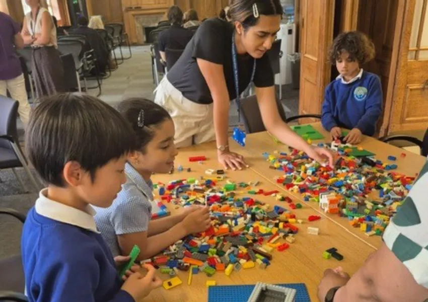 Children being distracted with lego bricks on a table