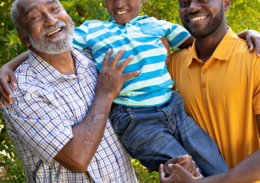 Family holding son in arms.