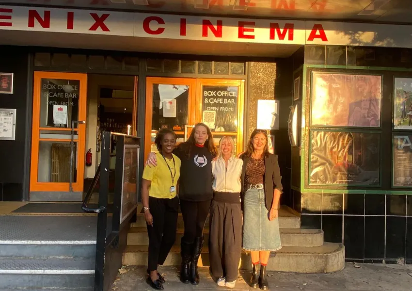 Four people standing outside the cinema