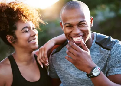 mid-30s couple laughing together