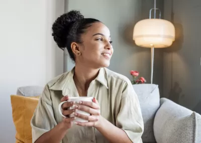 Lady holding a mug and looking away