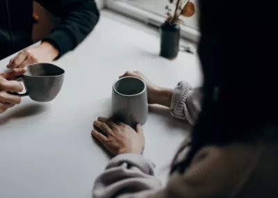 Two people drinking coffee