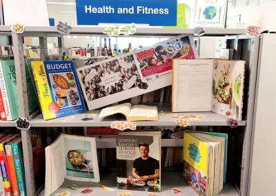 A bookshelf display of bean-related books, decorated with images of beans