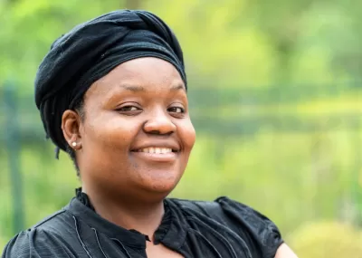 Woman wearing head covering smiling to camera