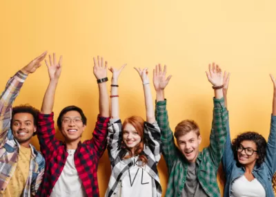 Smiley young people with their hands up