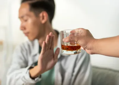 A gentleman refusing the offer of an alcoholic drink