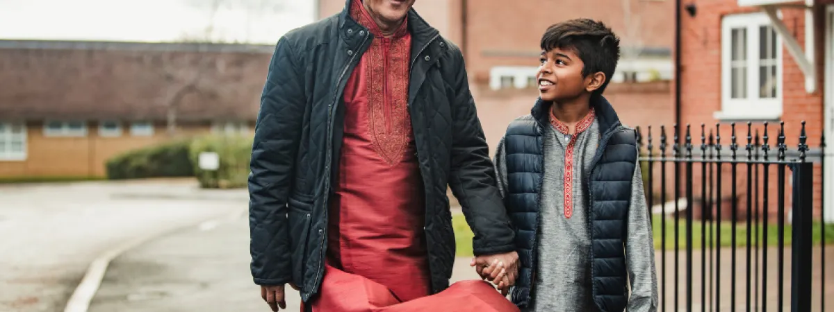 Father and son walking to school