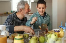 Grandfather and child cooking together